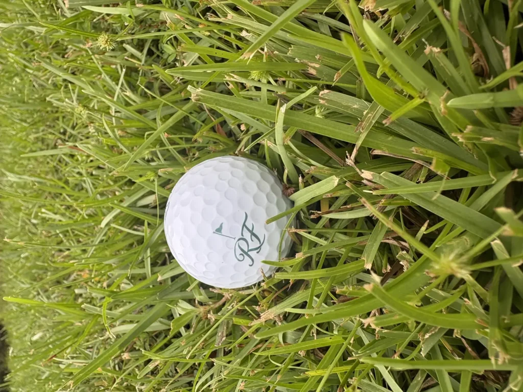 Riverside Fairways RF monogram golf ball in natural fairway grass